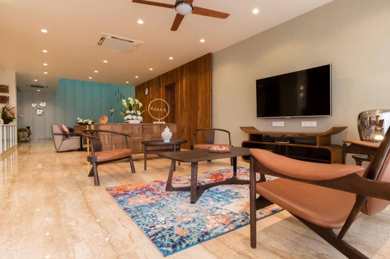 Residential reception and living area with wood panelling and marble flooring